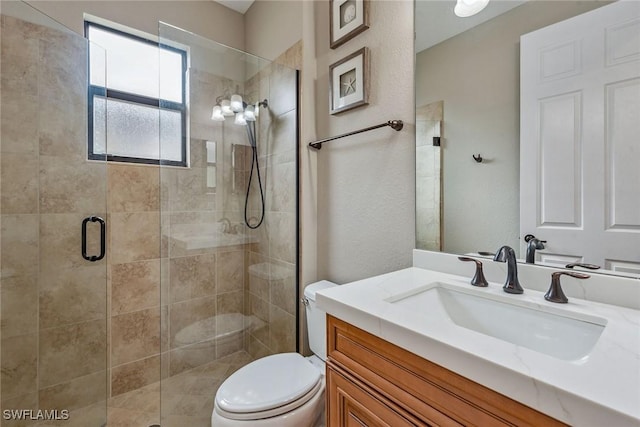 full bathroom with a stall shower, vanity, and toilet