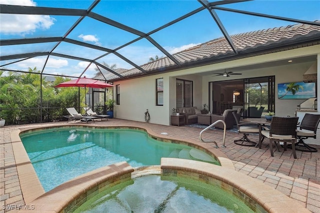 view of pool featuring a patio, a pool with connected hot tub, outdoor lounge area, glass enclosure, and ceiling fan