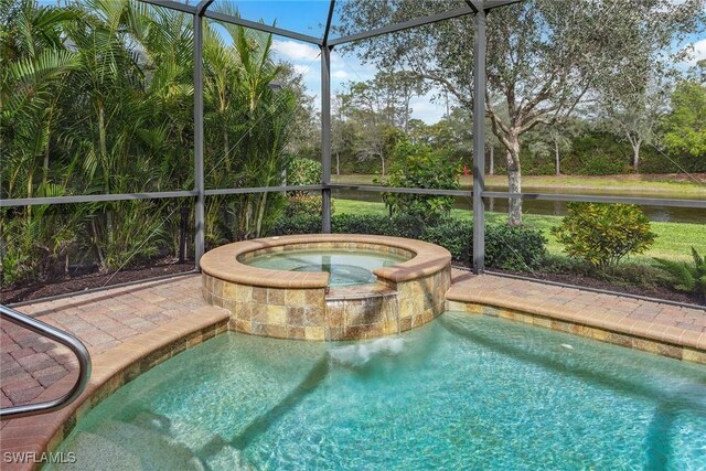 view of pool featuring a lanai and a pool with connected hot tub