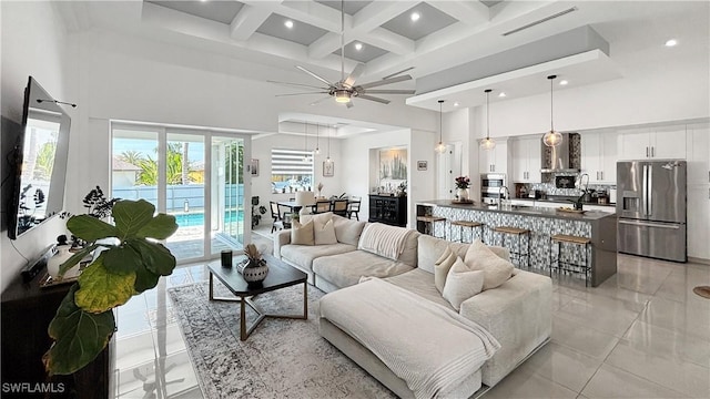 living area featuring recessed lighting, visible vents, a towering ceiling, coffered ceiling, and beamed ceiling