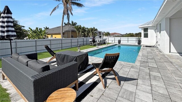 view of swimming pool featuring a patio, a fenced backyard, and a fenced in pool