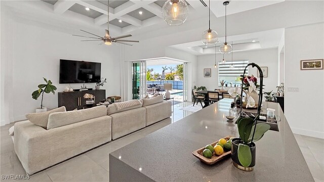 living area with beam ceiling, recessed lighting, ceiling fan, coffered ceiling, and baseboards