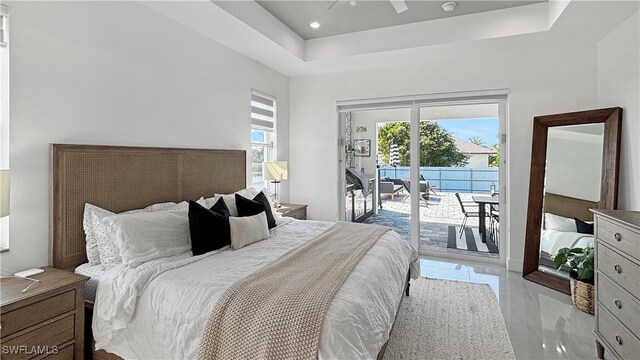 bedroom with access to exterior, a tray ceiling, marble finish floor, recessed lighting, and ceiling fan