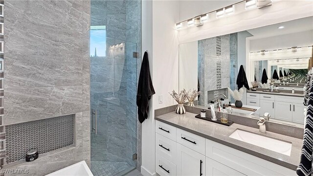 bathroom featuring a stall shower and vanity