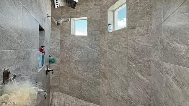 bathroom with tiled shower