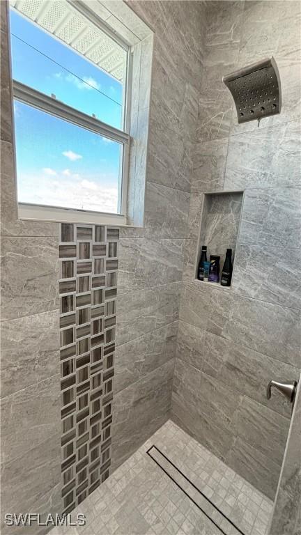 bathroom with a tile shower