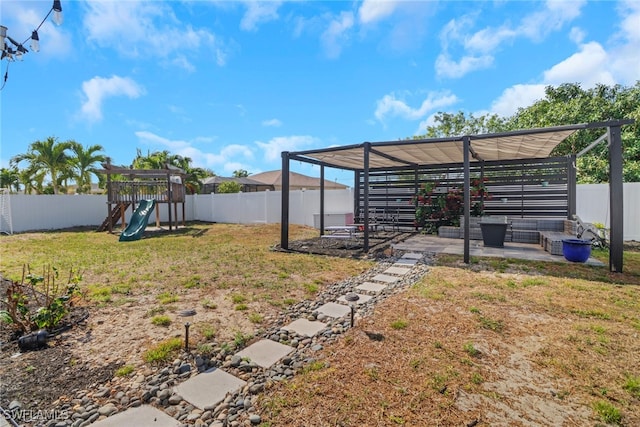 view of yard featuring a patio, a playground, and a fenced backyard