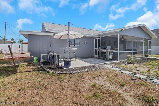 back of house featuring a sunroom, a patio area, fence, and ac unit