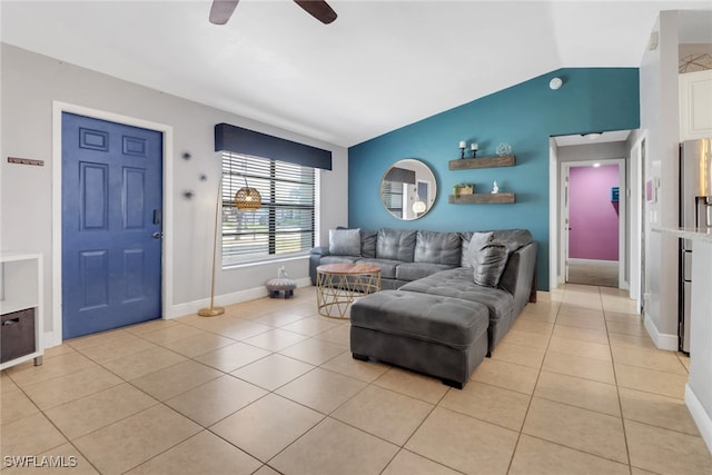 living area with lofted ceiling, baseboards, a ceiling fan, and light tile patterned flooring