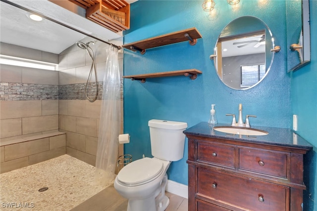 full bath with toilet, a tile shower, vanity, baseboards, and tile patterned floors