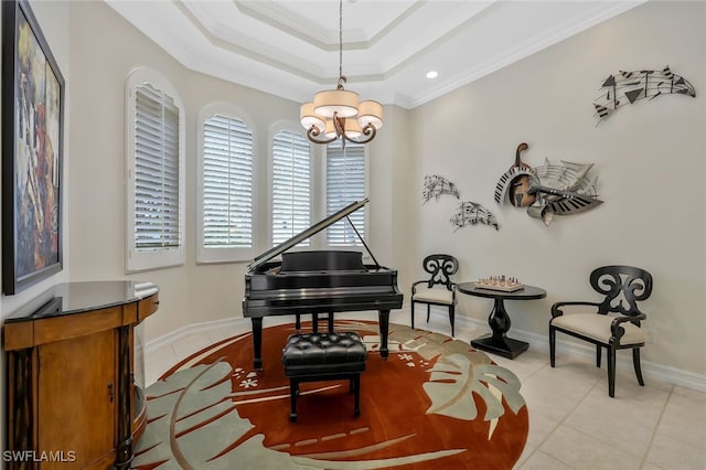 living area featuring a tray ceiling, light tile patterned floors, ornamental molding, a chandelier, and baseboards