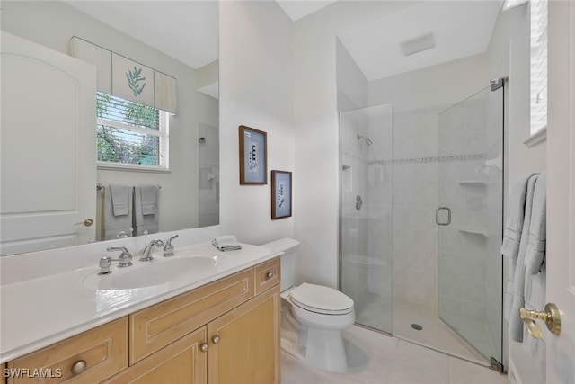 bathroom featuring a stall shower, vanity, toilet, and tile patterned floors