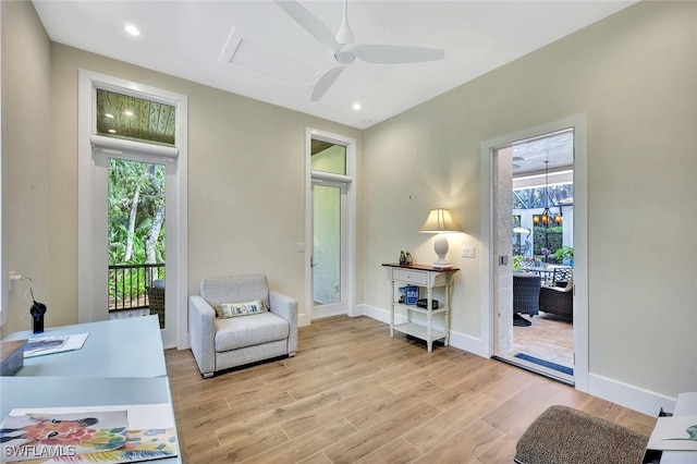 living area featuring ceiling fan, recessed lighting, light wood-type flooring, and baseboards