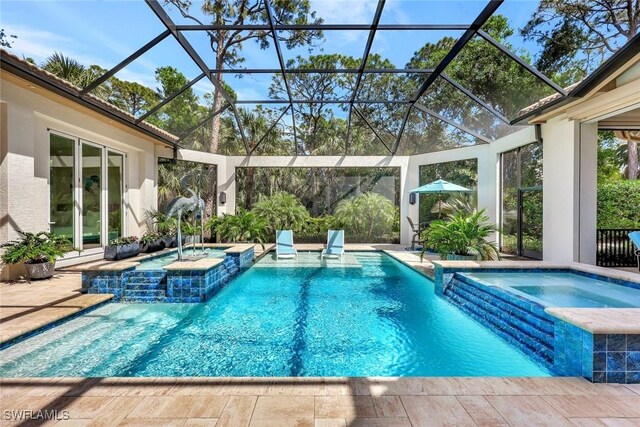 view of swimming pool with a patio area and a pool with connected hot tub