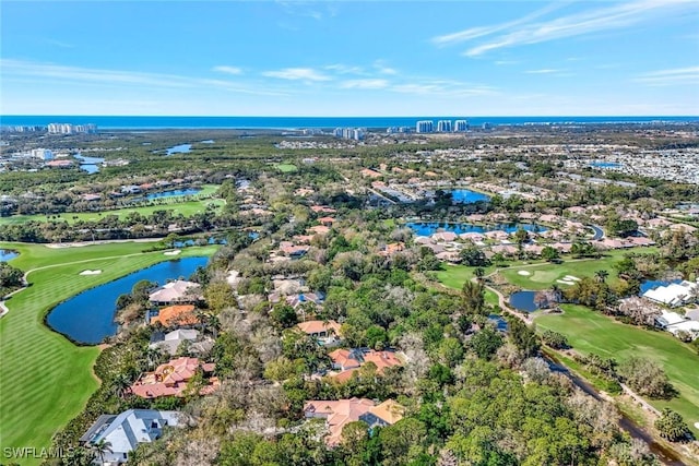 birds eye view of property featuring view of golf course and a water view