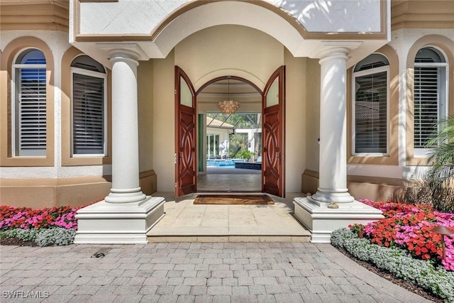 entrance to property featuring stucco siding