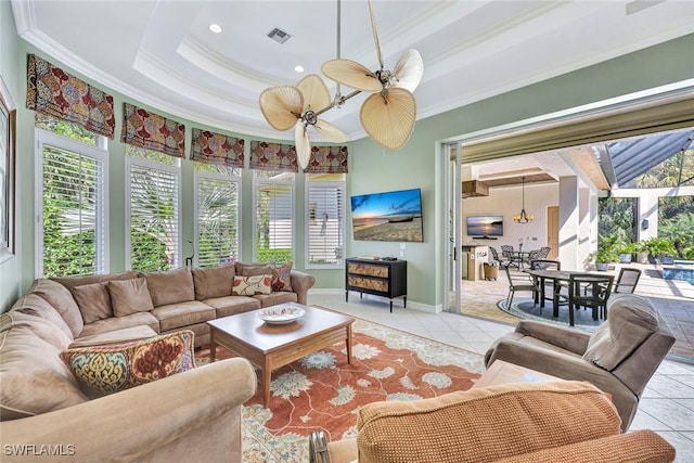 living area featuring ornamental molding, light tile patterned flooring, and a wealth of natural light