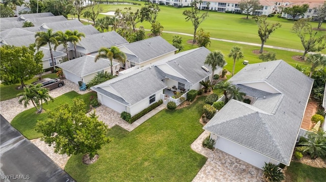 drone / aerial view with golf course view and a residential view