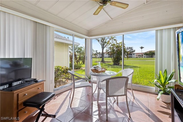 sunroom featuring lofted ceiling and ceiling fan