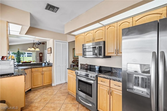 kitchen featuring light tile patterned floors, stainless steel appliances, visible vents, light brown cabinets, and a sink