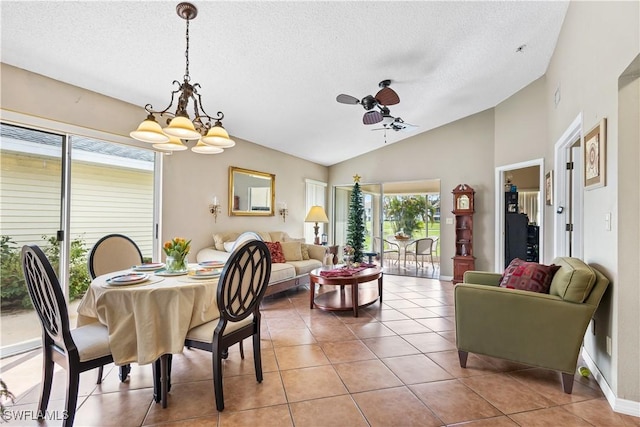 dining area with baseboards, lofted ceiling, light tile patterned flooring, a textured ceiling, and ceiling fan with notable chandelier