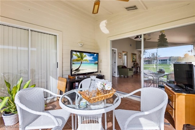 sunroom featuring a ceiling fan and visible vents