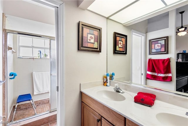 full bathroom featuring double vanity, walk in shower, and a sink