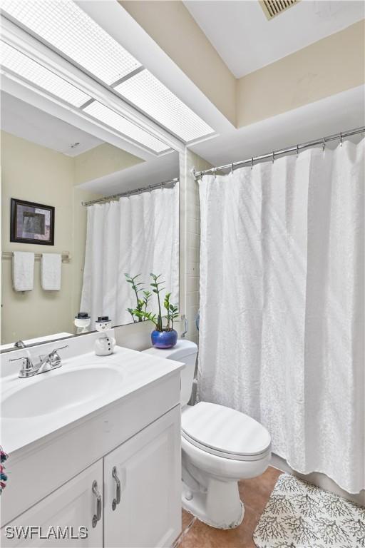 full bathroom with tile patterned flooring, vanity, and toilet