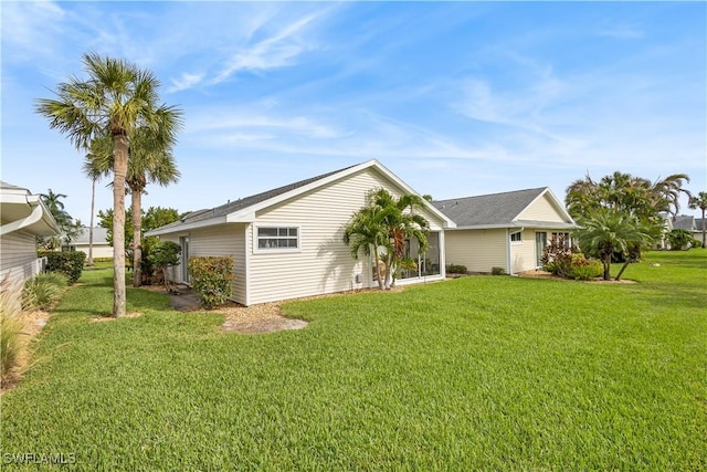 rear view of property featuring a lawn