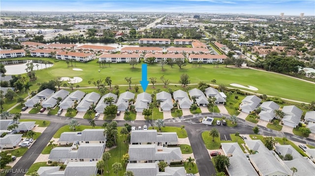 birds eye view of property featuring view of golf course and a residential view