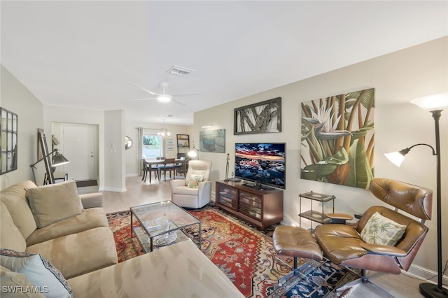 living area with visible vents, baseboards, and wood finished floors