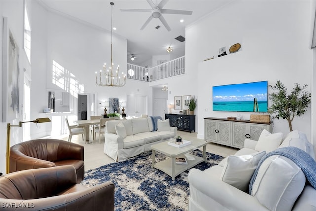 living room featuring ceiling fan with notable chandelier and a high ceiling