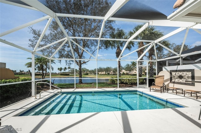 pool featuring a lanai, a water view, and a patio area