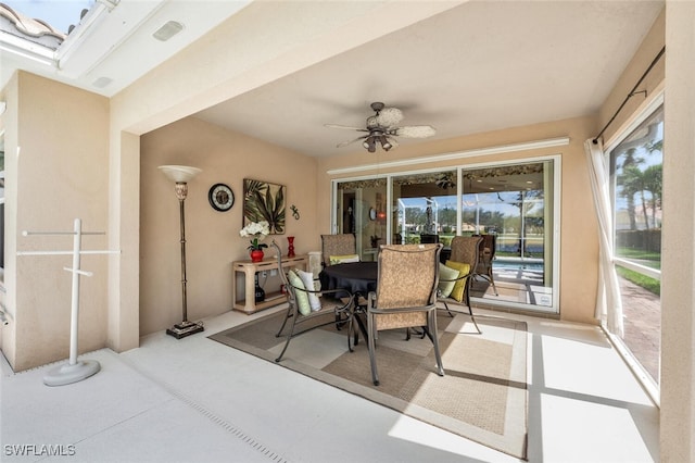 sunroom featuring ceiling fan