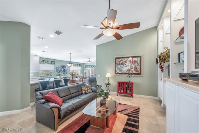 living area featuring baseboards, visible vents, a ceiling fan, and recessed lighting