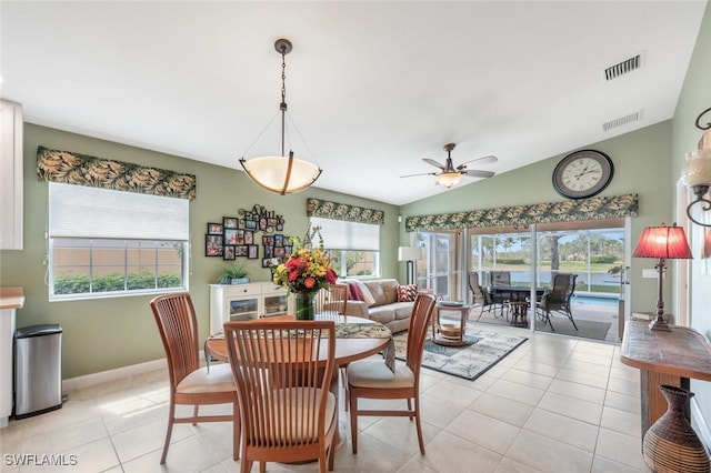 dining space with light tile patterned floors, visible vents, and a wealth of natural light