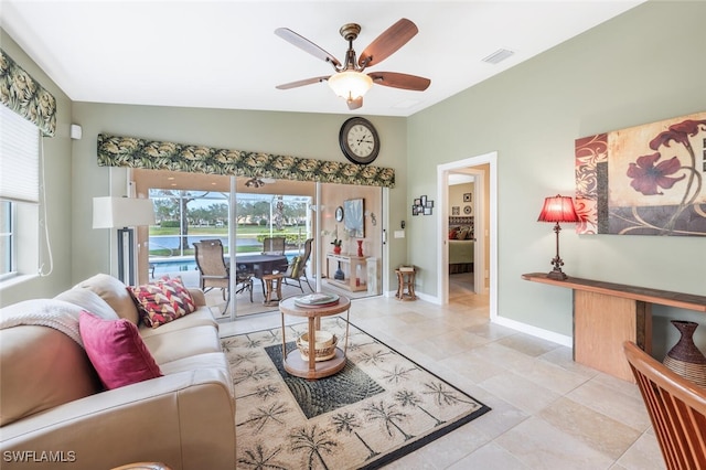 living room with lofted ceiling, baseboards, visible vents, and ceiling fan