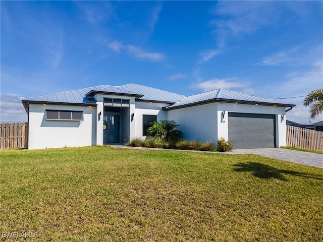 view of front of house with an attached garage, fence, a front lawn, and stucco siding