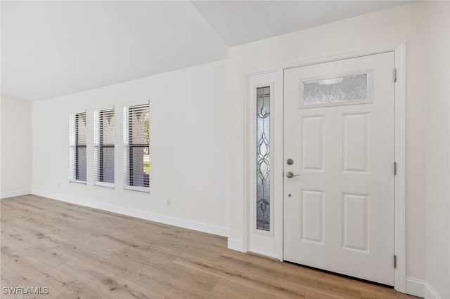 foyer entrance featuring light wood-style floors and baseboards