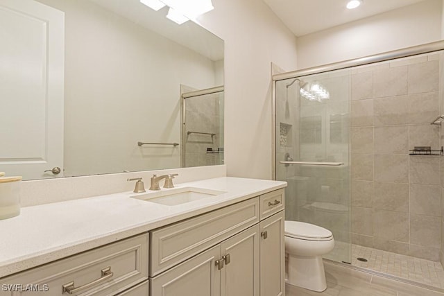 bathroom featuring toilet, vanity, and an enclosed shower