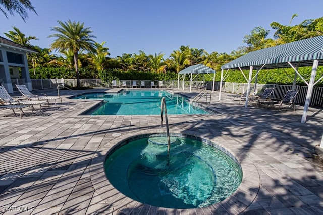 view of swimming pool with a patio, a hot tub, and a gazebo