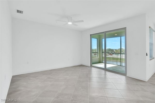 unfurnished room featuring a ceiling fan, visible vents, and baseboards