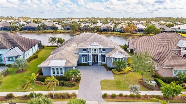 bird's eye view with a residential view and a water view