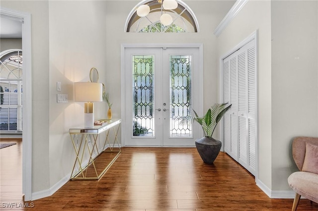 entryway featuring french doors, a wealth of natural light, and wood finished floors