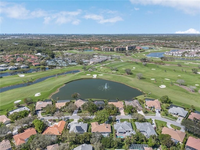 birds eye view of property with view of golf course, a water view, and a residential view