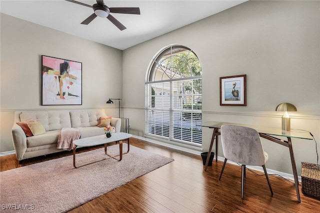 living room with wood finished floors and a ceiling fan