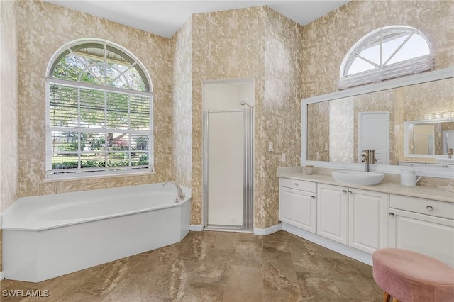 full bathroom featuring a shower stall, wallpapered walls, a bathing tub, and vanity