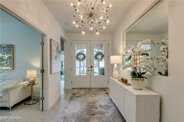 foyer with french doors, light tile patterned flooring, and an inviting chandelier