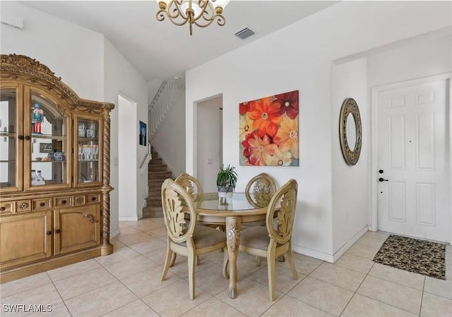 dining room featuring a chandelier, light tile patterned floors, stairway, baseboards, and visible vents