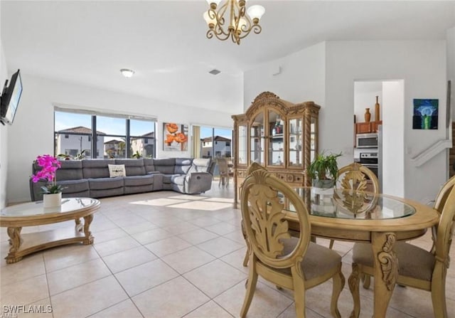 dining space featuring a healthy amount of sunlight, a notable chandelier, light tile patterned flooring, and visible vents